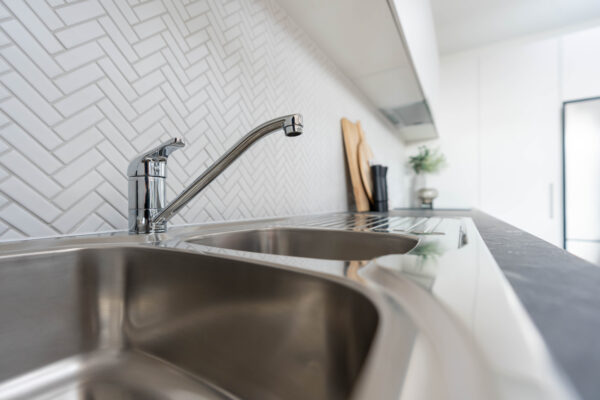 Close up image of an Oliveri double bowl sink with drainer