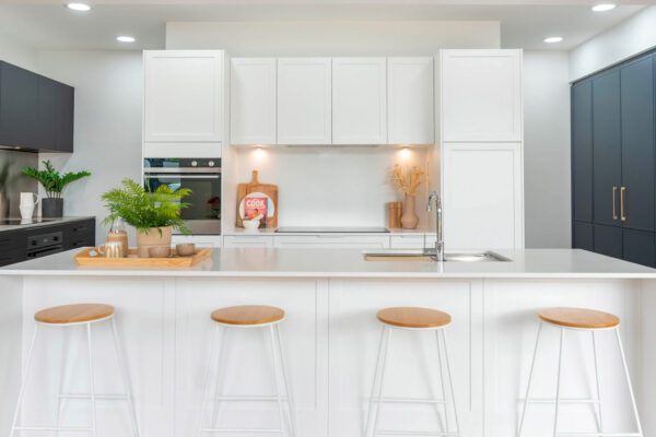 White Hamptons look kitchen with our Barossa range cabinetry. White stone benchtops with a waterfall edge