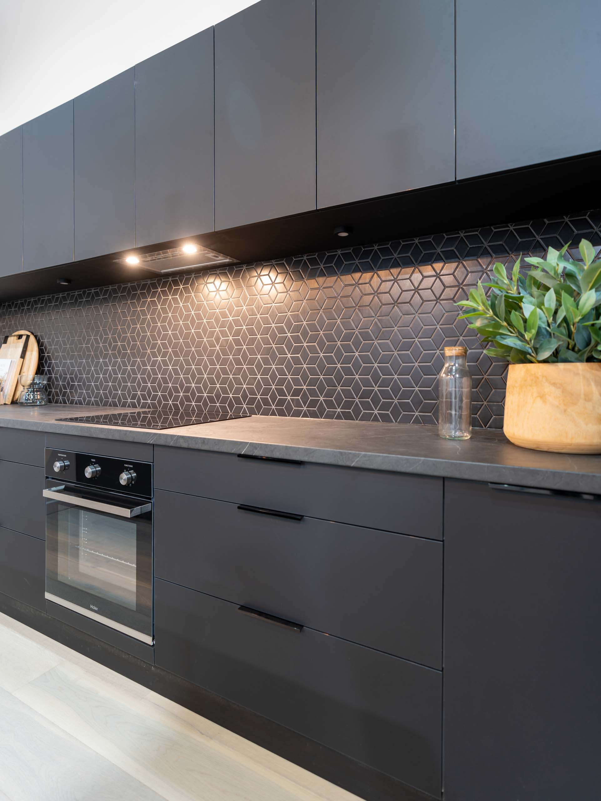 Image of black supermatte kitchen display with black kitchen appliances.