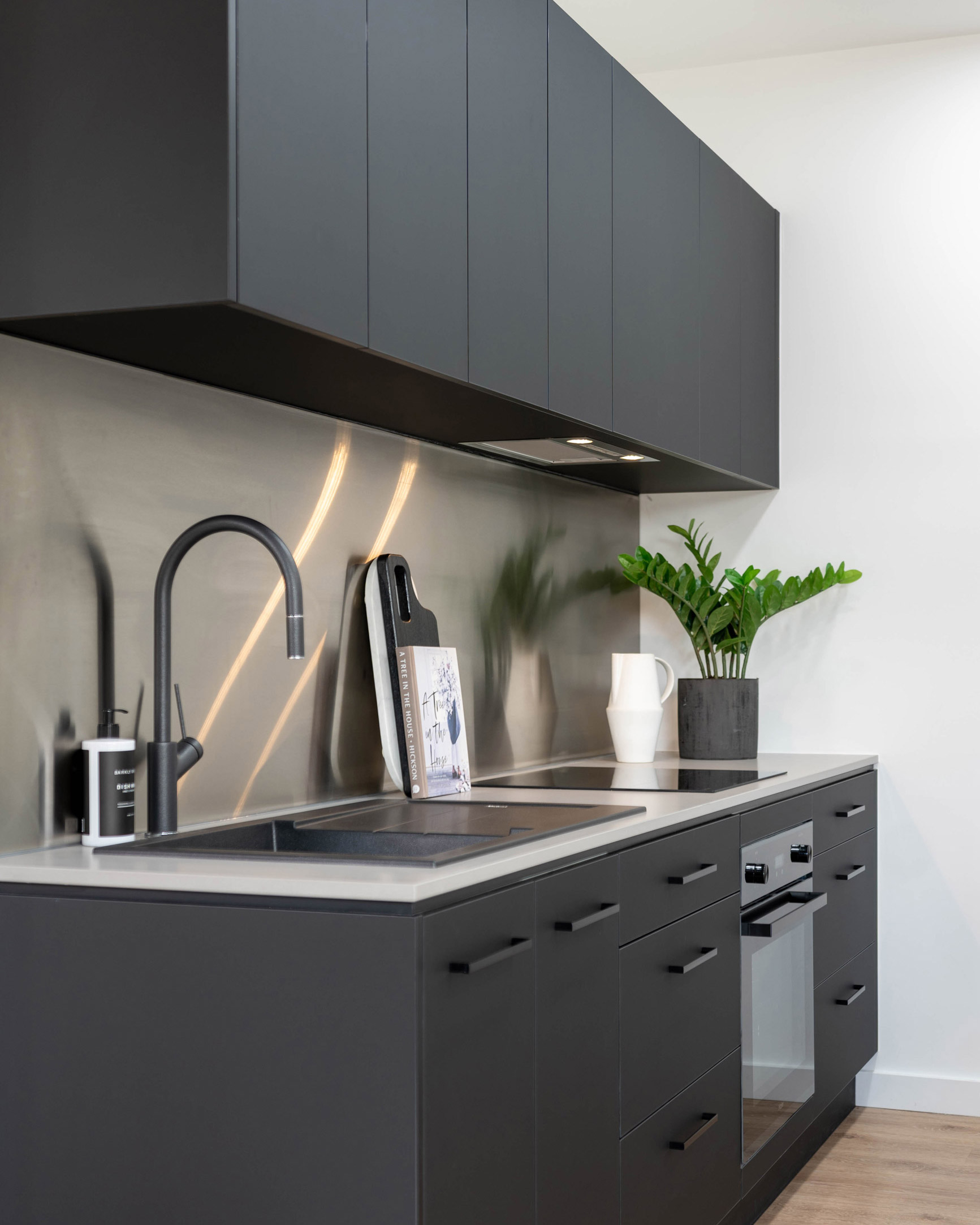 Image of black supermatte kitchen at U-Install-It Kitchens showroom at Glandore. Featuring black kitchen sink & tap, and black handles and black Haier appliances.