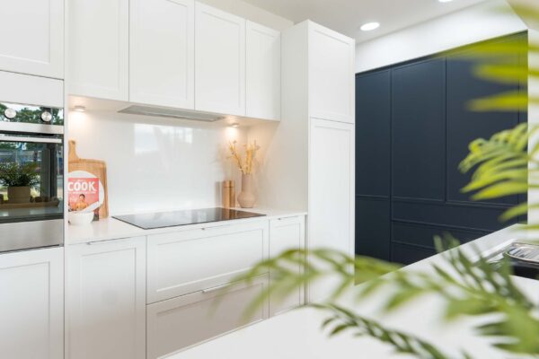White cabinetry in our Barossa range with white lip pull handles. Fisher & Paykel appliances