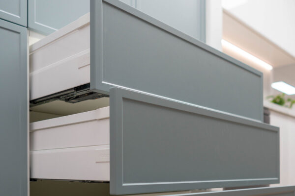 Sage green cabinetry with drawer units for easy access