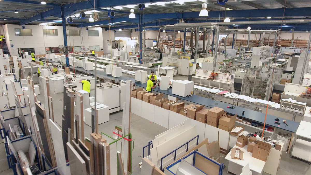 Image of our local state of the art factory, birds eye showing the size of the factory, and the pre-assembled cabinets being made